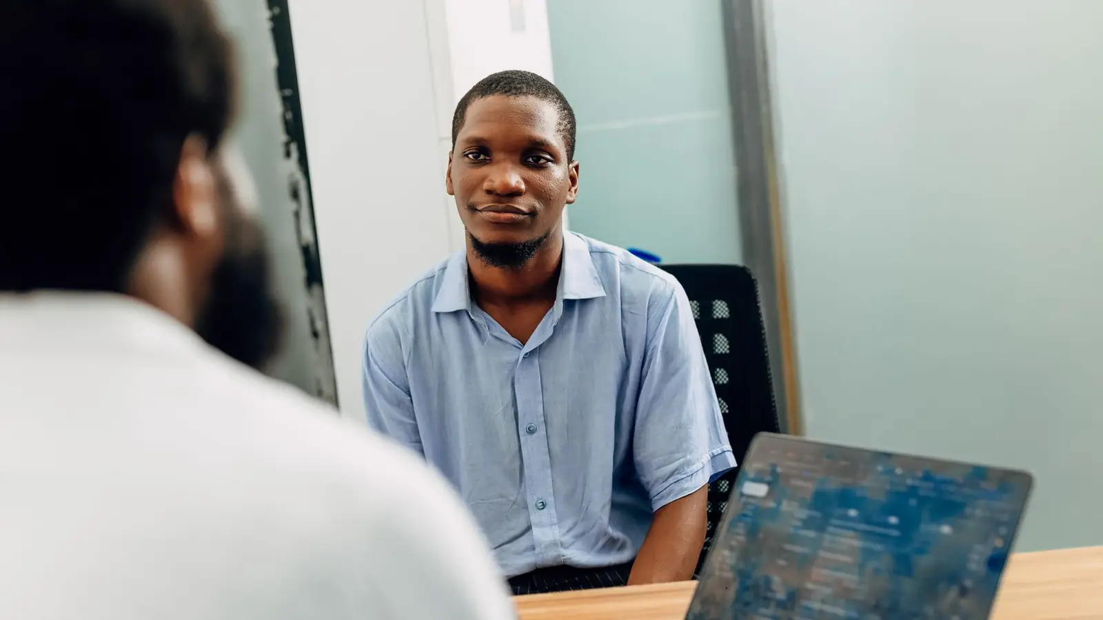 A candidate in a job interview in a modern office in Lagos
