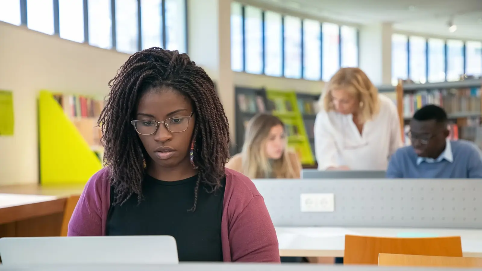A student working on a laptop in a library